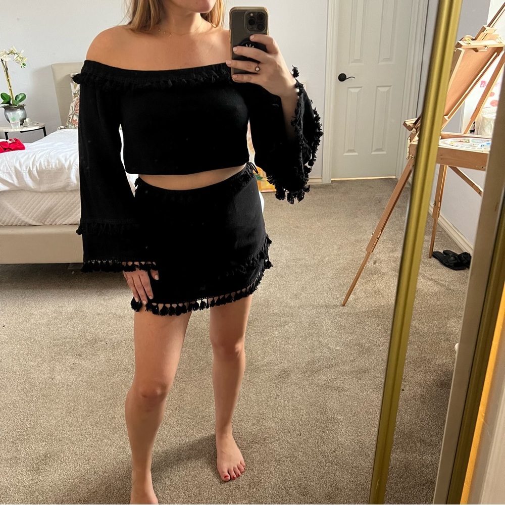 Black crop top and skirt with fringe detailing. Never worn still has tags.